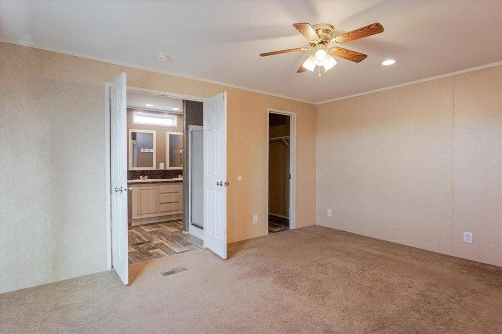 126 Starry Sky Court, Springtown, TX 76082 Carpeted room featuring a ceiling fan with integrated lighting, recessed lighting, and a doorway to a walk-in closet