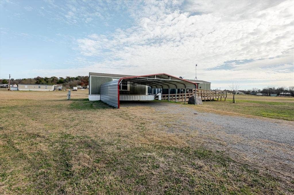 126 Starry Sky Court, Springtown, TX 76082 Carport has two parking spaces. There is a ramp leading to deck, Perfect for moving furniture in.