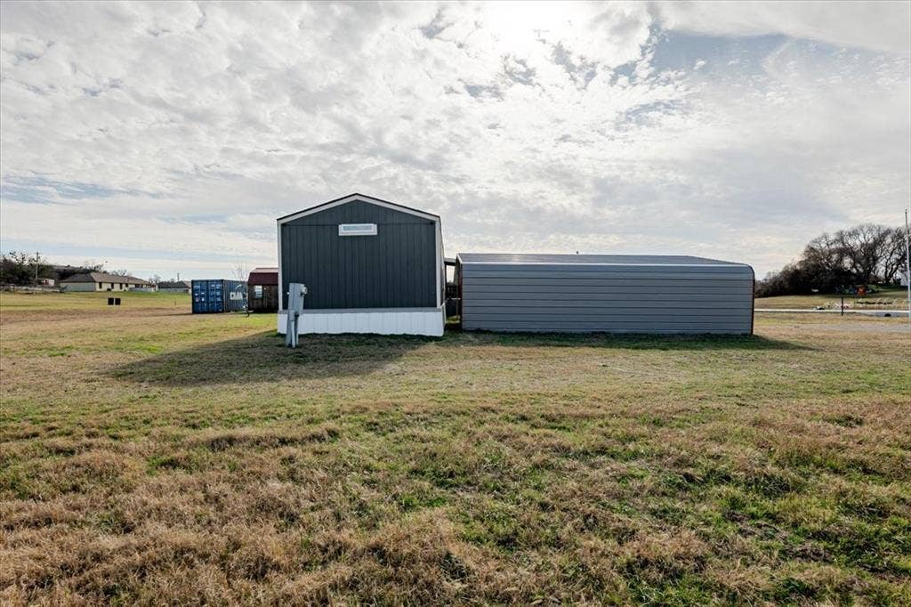126 Starry Sky Court, Springtown, TX 76082 End of house showing carport, Convex and wooden work shop with electricity.