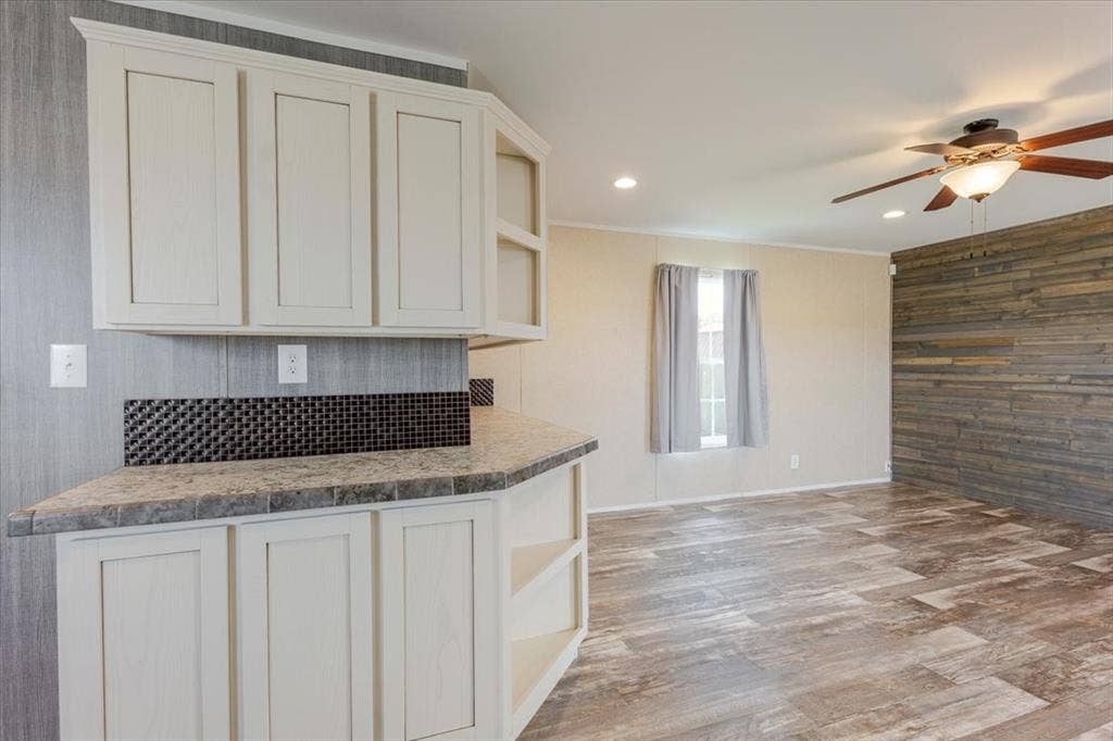 126 Starry Sky Court, Springtown, TX 76082 Kitchen pass-through featuring light-toned cabinetry, a mosaic tile backsplash, and a countertop with integrated edge tiling
