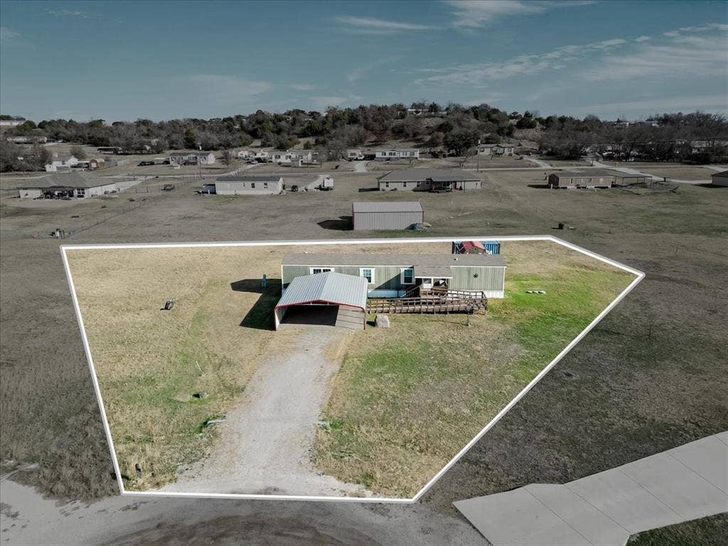 126 Starry Sky Court, Springtown, TX 76082 Single-story residence with a light green exterior siding