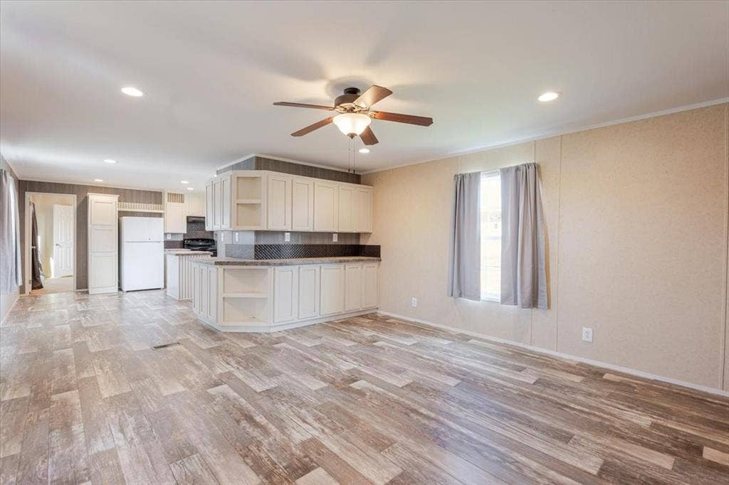 126 Starry Sky Court, Springtown, TX 76082 Open-concept living space featuring wood-finish flooring, recessed lighting, and a ceiling fan