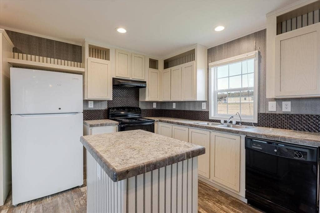 126 Starry Sky Court, Springtown, TX 76082 Open-concept kitchen featuring an island with a laminate countertop, light cabinetry, white refrigerator, black range, and black dishwasher