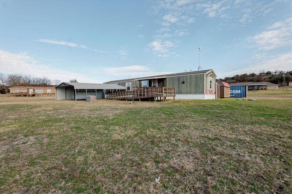 126 Starry Sky Court, Springtown, TX 76082 Front view including ramp and carport.