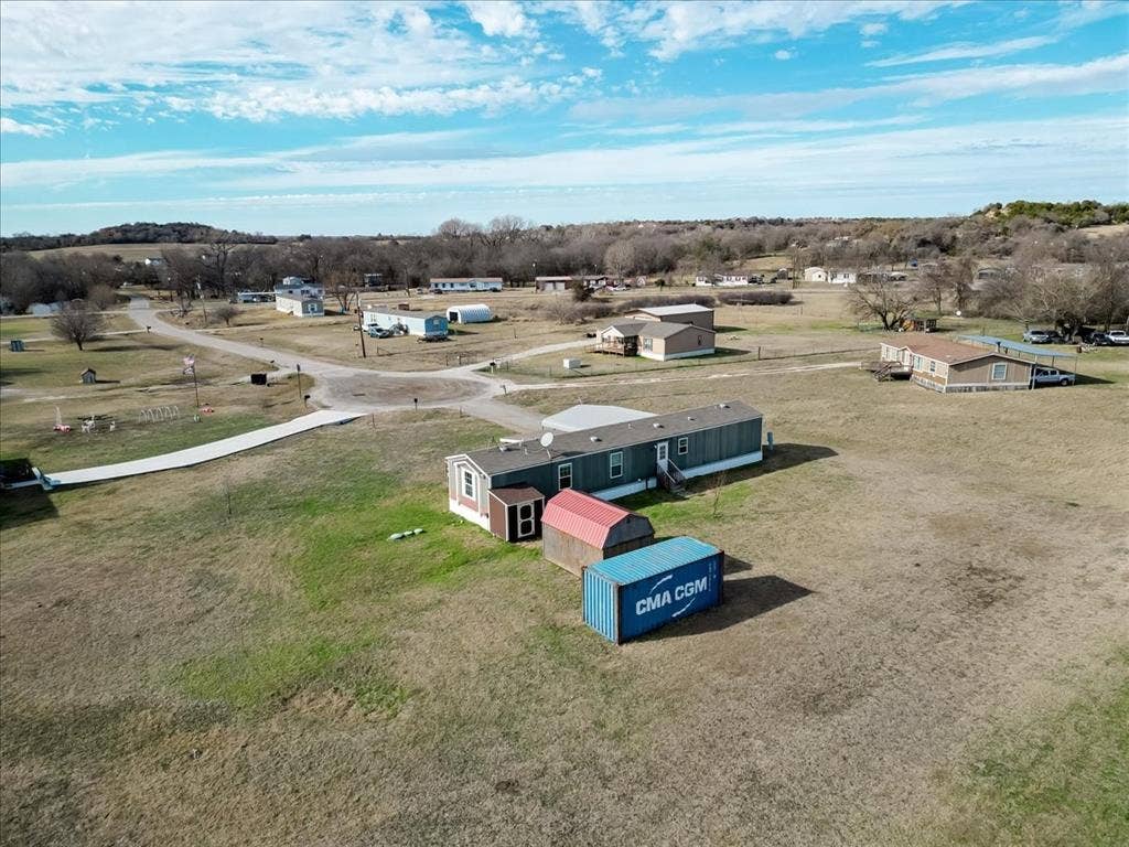 126 Starry Sky Court, Springtown, TX 76082 Single-story property featuring a light blue exterior, white trim, and a dark shingle roof