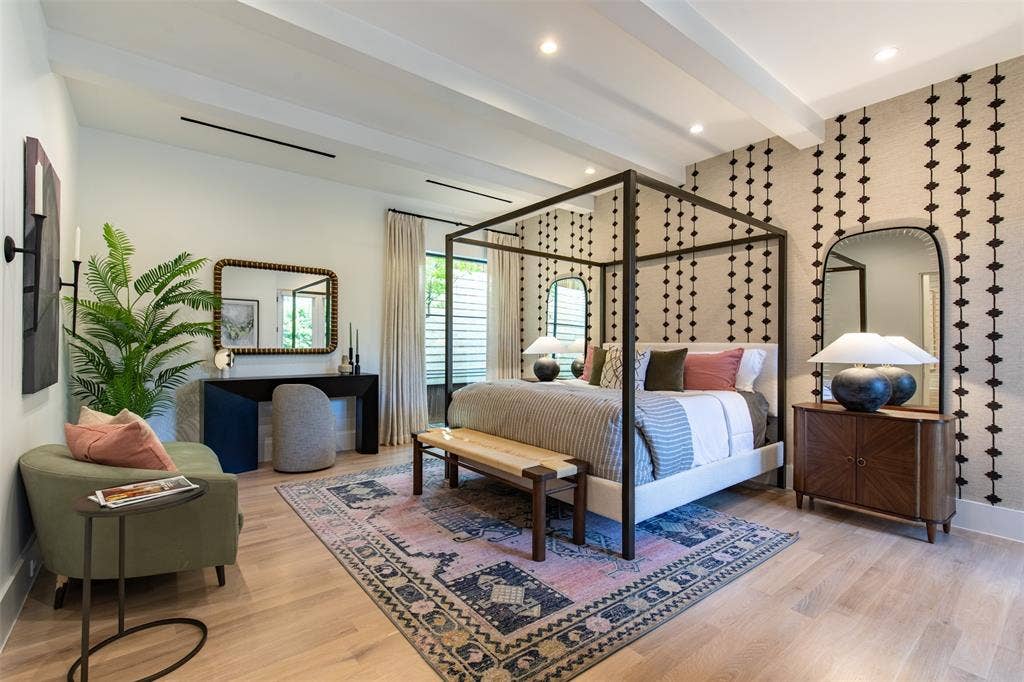 6979 Bob O Link Drive, Dallas, TX 75214 Spacious room featuring light wood-finish flooring, exposed ceiling beams, a patterned accent wall, and recessed lighting