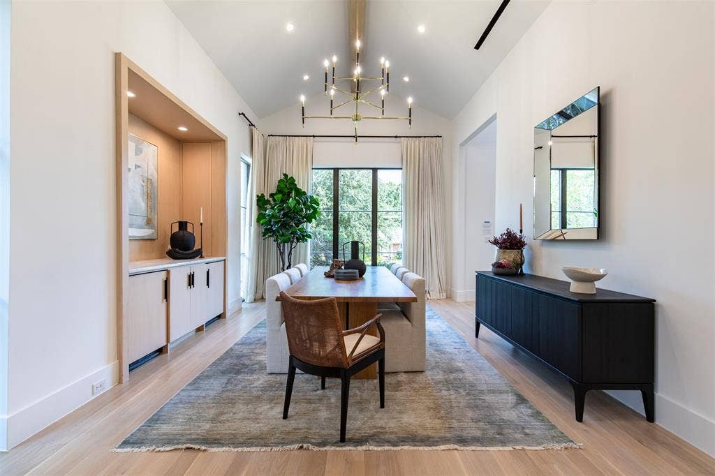 6979 Bob O Link Drive, Dallas, TX 75214 Dining area featuring a vaulted ceiling with a linear chandelier, recessed lighting, and wood-finish flooring