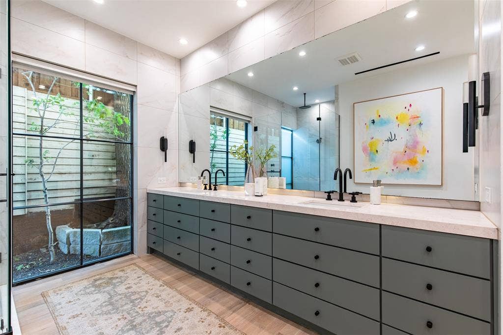 6979 Bob O Link Drive, Dallas, TX 75214 Dual vanity featuring a light-toned countertop and matte gray cabinetry