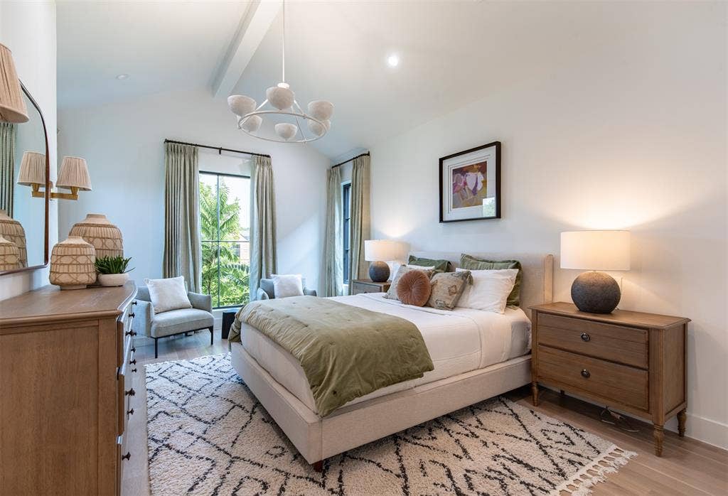 6979 Bob O Link Drive, Dallas, TX 75214 Room featuring vaulted ceilings with exposed beams, wood-finish flooring, two large windows with dark trim, and a contemporary chandelier