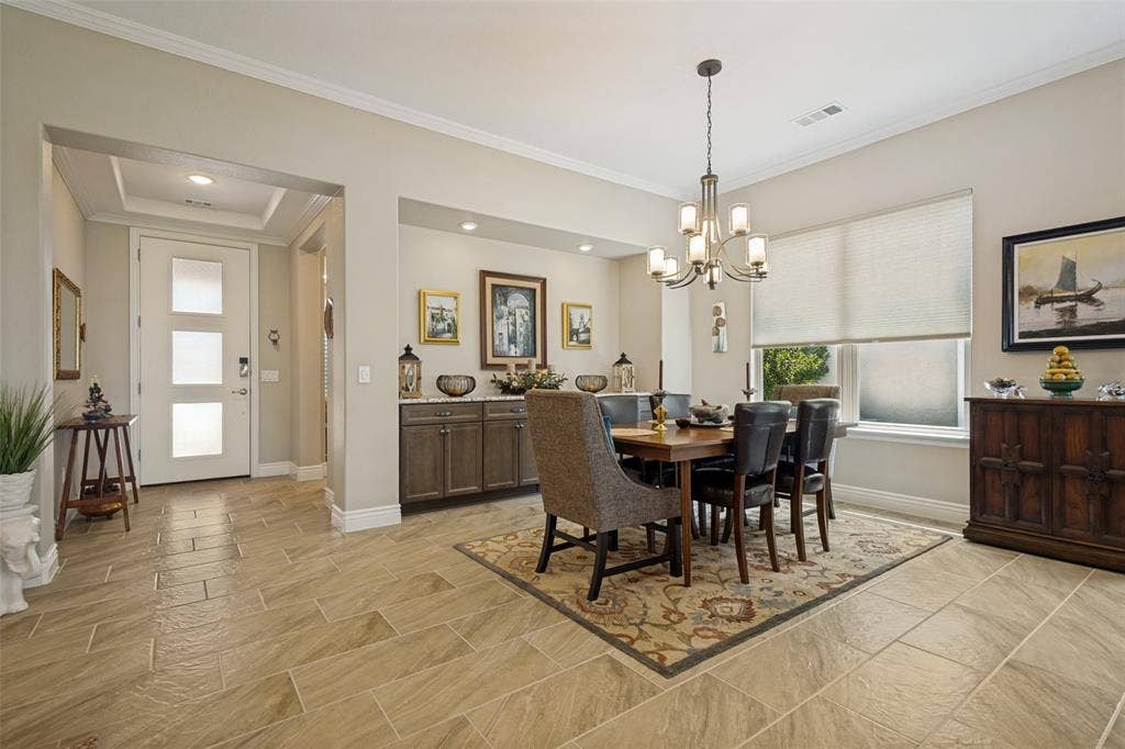 OPEN DINING AREA PROVIDES A GREAT SPACE TO ENTERTAIN AND IS COMPLETE WITH BUILT IN BUFFET WITH GRANITE COUNTER AND DESIGNER CHANDELIER.