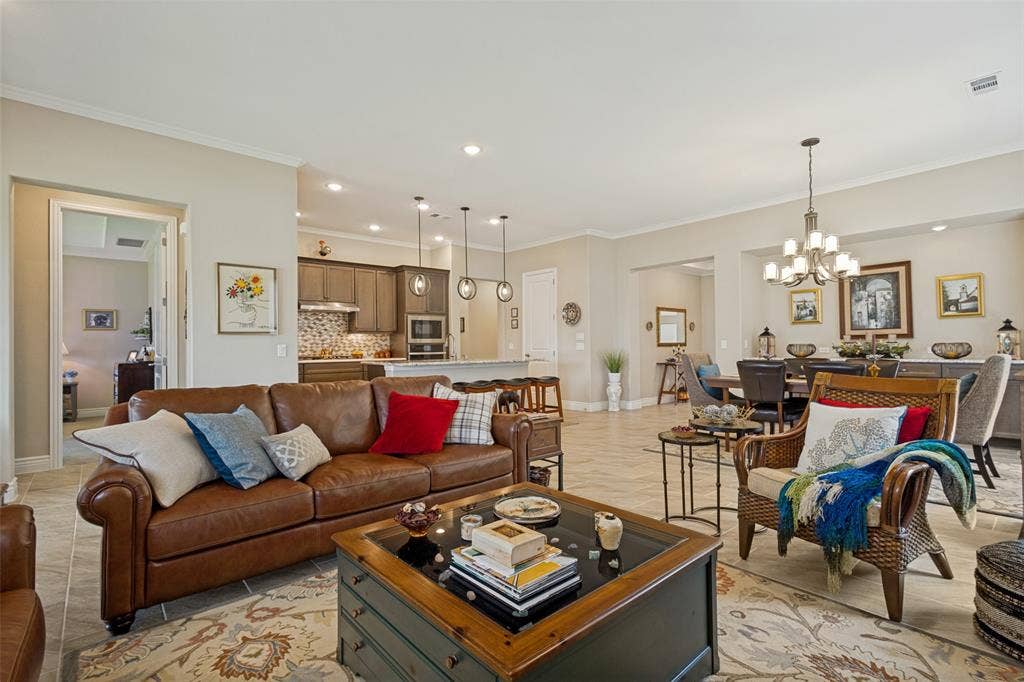 LIVING ROOM SHOWS RELATIONSHIP TO KITCHEN, DINING, ENTRY WAY TO PRIMARY BEDROOM AND FRONT ENTRY.