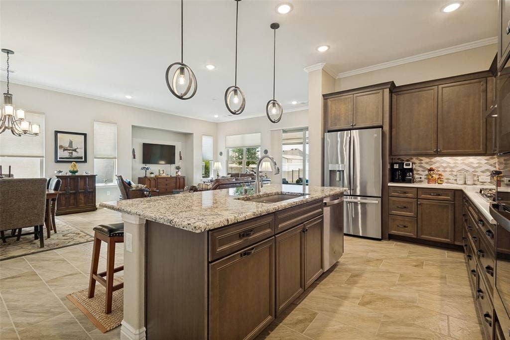 CABINETS IN SMOLDER ARE SO RICH AND ELEGANT. STAINLESS APPLIANCES INCLUDING REFRIGERATOR FOR THE NEW OWNERS.