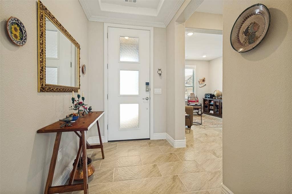LARGE PLANK CERAMIC TILE IN NEUTRAL SHADES OF BEIGE AND TAUPE IS FEATURED IN MOST ROOMS. A PEEK INTO THE DEN/STUDY.