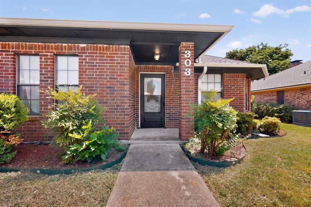 303 Stoneybrook Drive, Wylie, TX 75098 Brick exterior with covered entry and concrete walkway