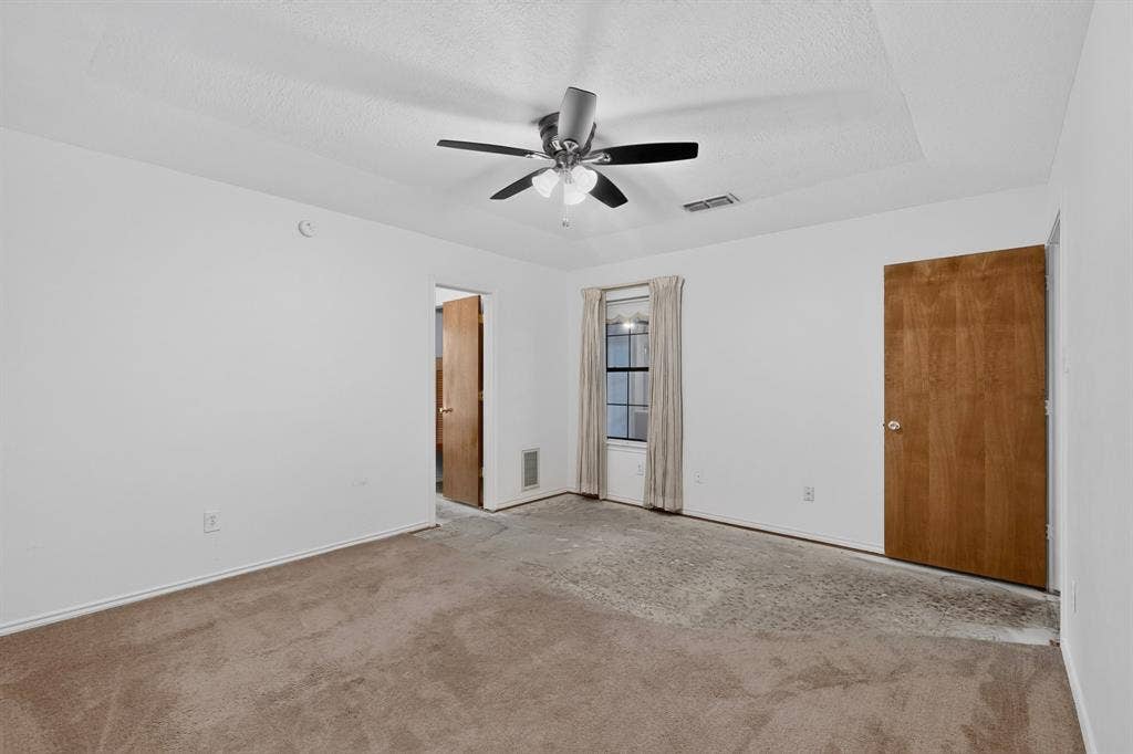 303 Stoneybrook Drive, Wylie, TX 75098 Carpeted room with white walls, a ceiling fan, and a single window