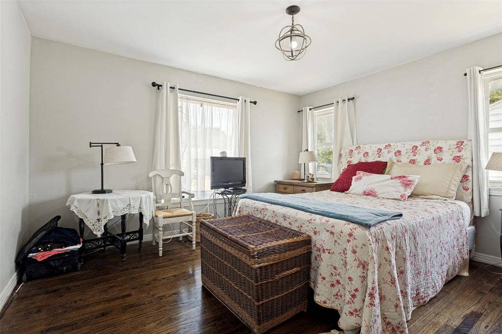 2312 Brooks Street, Garland, TX 75041 Hardwood flooring, light-toned walls, ceiling-mounted light fixture, window with drapery, and a second window