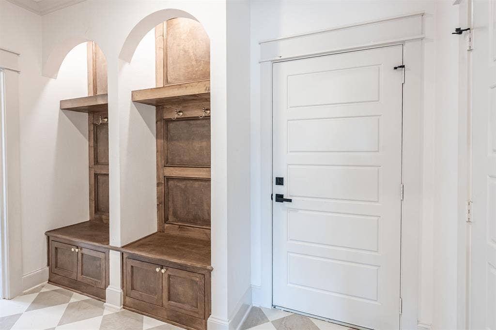 17049 Island Lake Drive, Tyler, TX 75708 Built-in wooden bench with storage, arched alcoves, and decorative wall hooks