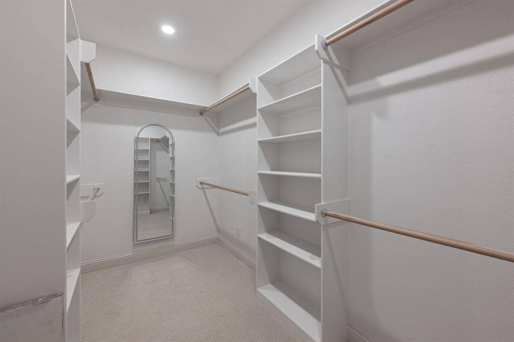 17049 Island Lake Drive, Tyler, TX 75708 Recessed lighting, wall-mounted mirror, built-in shelving, wood-finish closet rods, and carpet flooring