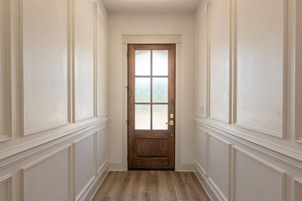 17049 Island Lake Drive, Tyler, TX 75708 Wood-finish flooring leading to a paneled wood entry door with frosted glass inserts