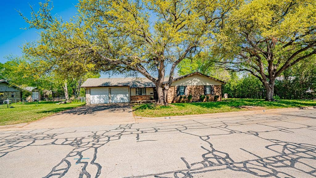 1110 Penrod Street, Granbury, TX 76048 Front view of home. Two car garage