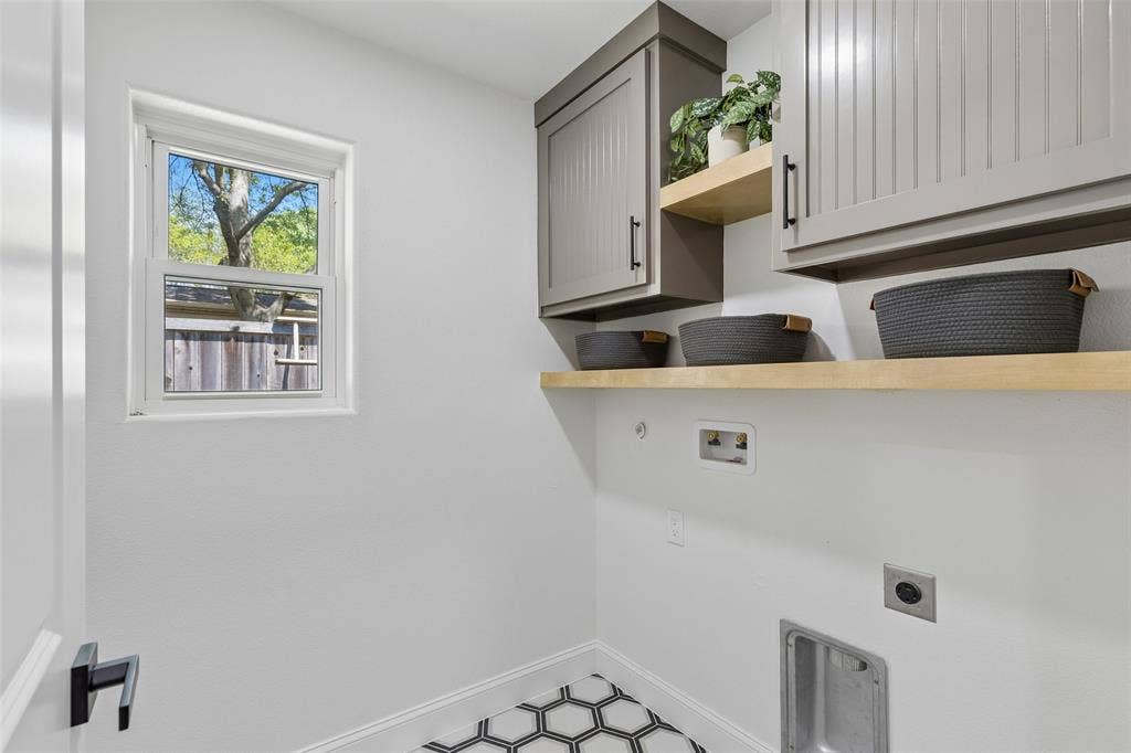 12124 Dixfield Drive, Dallas, TX 75218 White walls featuring a single window, built-in upper cabinetry, open shelving, and hexagonal floor tiling