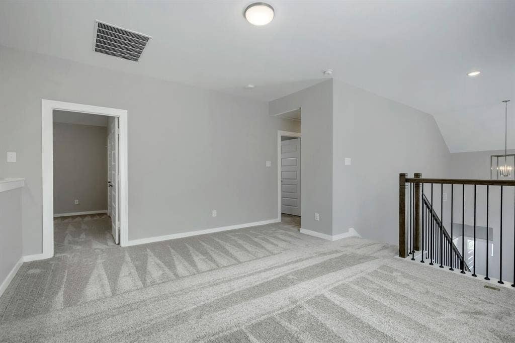 3925 Chesapeake Lane, Heartland, TX 75126 Carpeted upstairs landing with light gray walls, white trim, recessed lighting, and a dark wood and black metal baluster railing