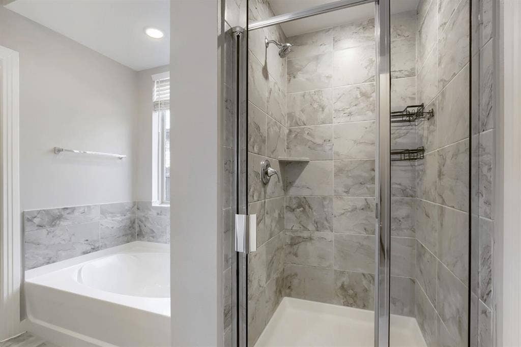 3925 Chesapeake Lane, Heartland, TX 75126 Walk-in shower with clear glass enclosure, tiled walls, and built-in shelving