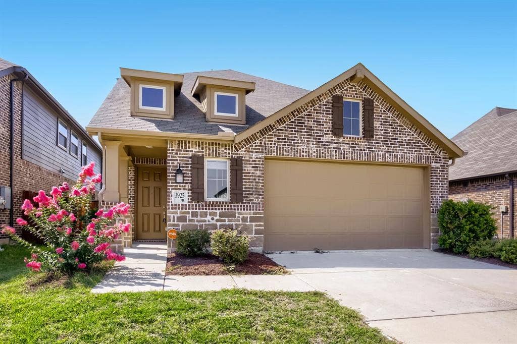 3925 Chesapeake Lane, Heartland, TX 75126 Brick and stone exterior with decorative gable detailing and arched entryway
