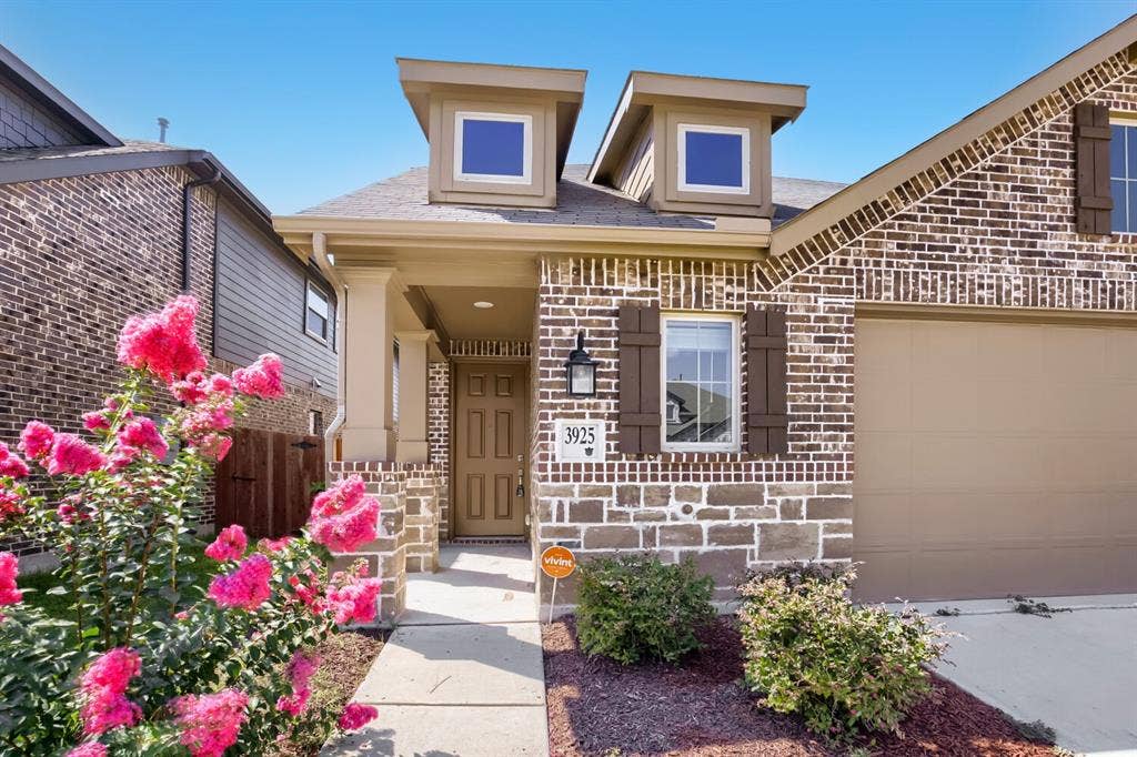 3925 Chesapeake Lane, Heartland, TX 75126 Charming brick facade with distinctive dual dormers and arched entryway