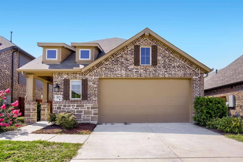 3925 Chesapeake Lane, Heartland, TX 75126 Brick and stone exterior with elegant architectural detailing and multiple gabled rooflines