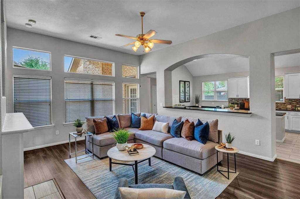 1601 Long Prairie Court, Allen, TX 75002 High ceilings, wood-finish flooring, built-in ceiling fan, arched doorway, and a kitchen pass-through with a breakfast bar