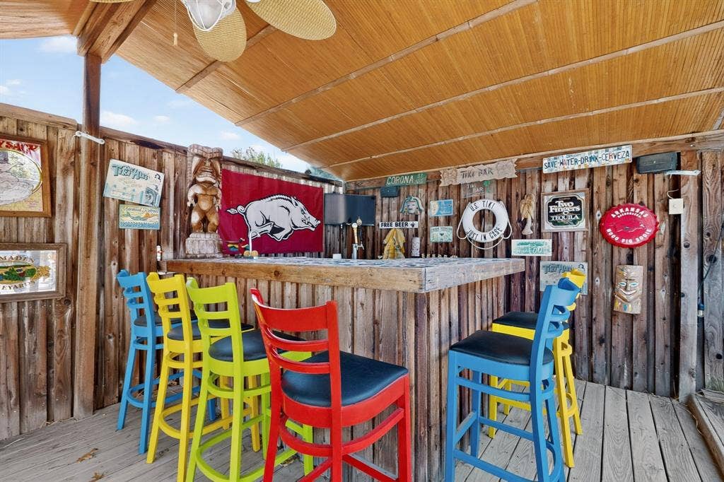 3820 Nash Lane, Plano, TX 75025 Outdoor cabana bar area featuring a wood-plank counter, wood-paneled walls, a slatted wood ceiling, and an overhead ceiling fan