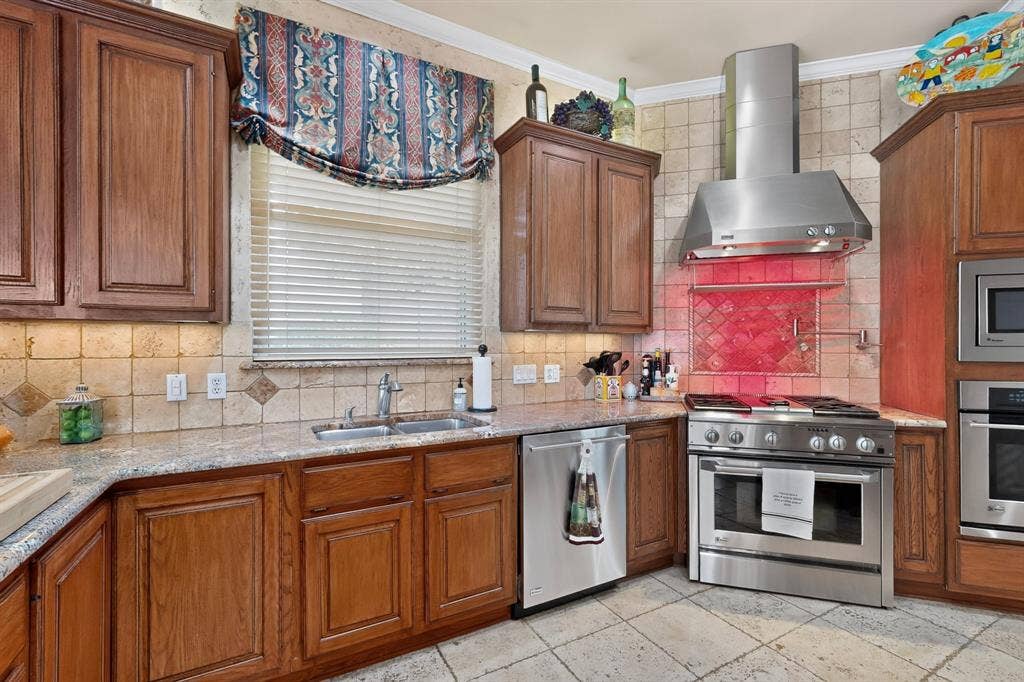 3820 Nash Lane, Plano, TX 75025 Wood cabinetry, light-toned tiled backsplash, granite-style countertops, stainless steel appliances, and tiled flooring