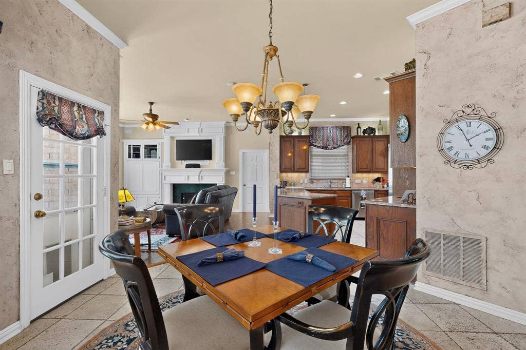3820 Nash Lane, Plano, TX 75025 Open-concept dining area with tile flooring and a decorative chandelier