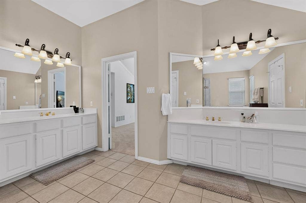 3820 Nash Lane, Plano, TX 75025 Dual vanity areas featuring white cabinetry and light-toned countertops