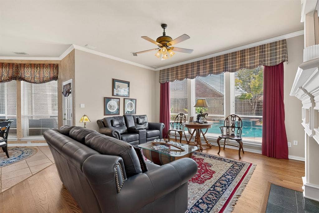 3820 Nash Lane, Plano, TX 75025 Warm interior featuring wood-finish flooring, a ceiling fan with integrated lighting, and crown molding