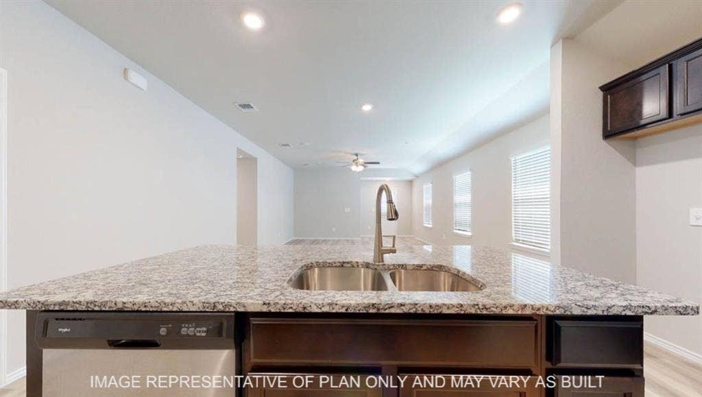 3016 Cyprian Road, Lorena, TX 76655 Kitchen island with a double basin stainless steel sink, a chrome gooseneck faucet, and integrated dishwasher