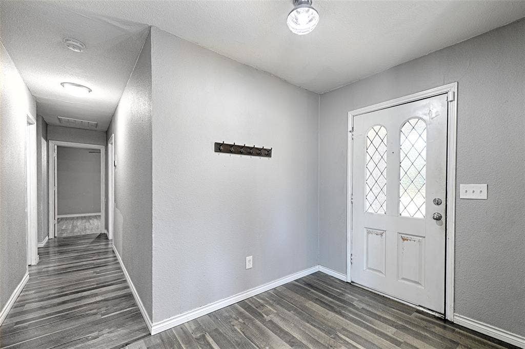 1223 Sequoia Drive, DeSoto, TX 75115 Entryway featuring a white door with decorative glass inserts, wood-finish flooring, and light-toned walls