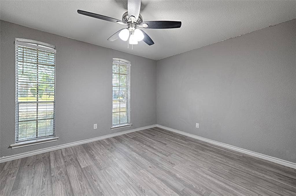 1223 Sequoia Drive, DeSoto, TX 75115 Wood-finish flooring, two windows with blinds, ceiling fan with integrated lighting