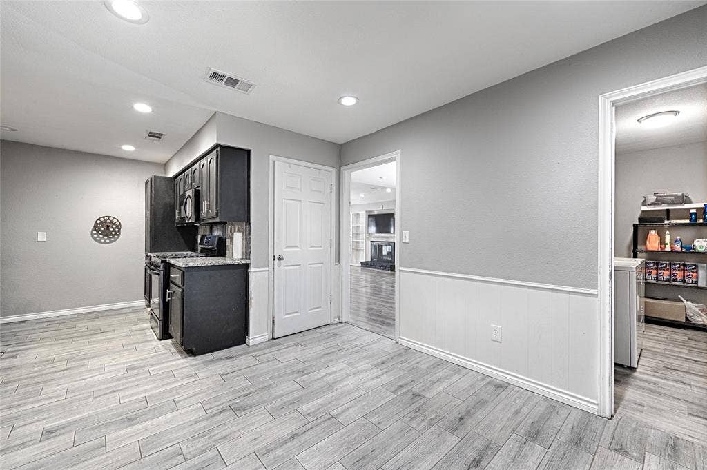 1223 Sequoia Drive, DeSoto, TX 75115 Kitchenette featuring dark-finish cabinetry, built-in appliances, wood-finish flooring, and recessed lighting