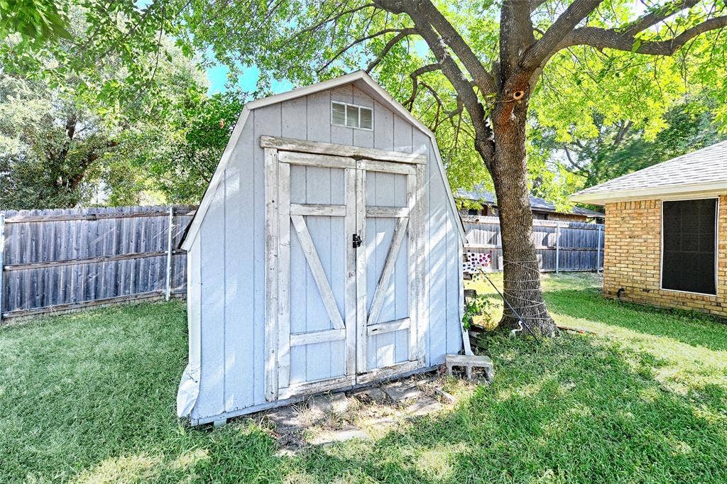 1223 Sequoia Drive, DeSoto, TX 75115 Storage shed with double barn doors and a small window