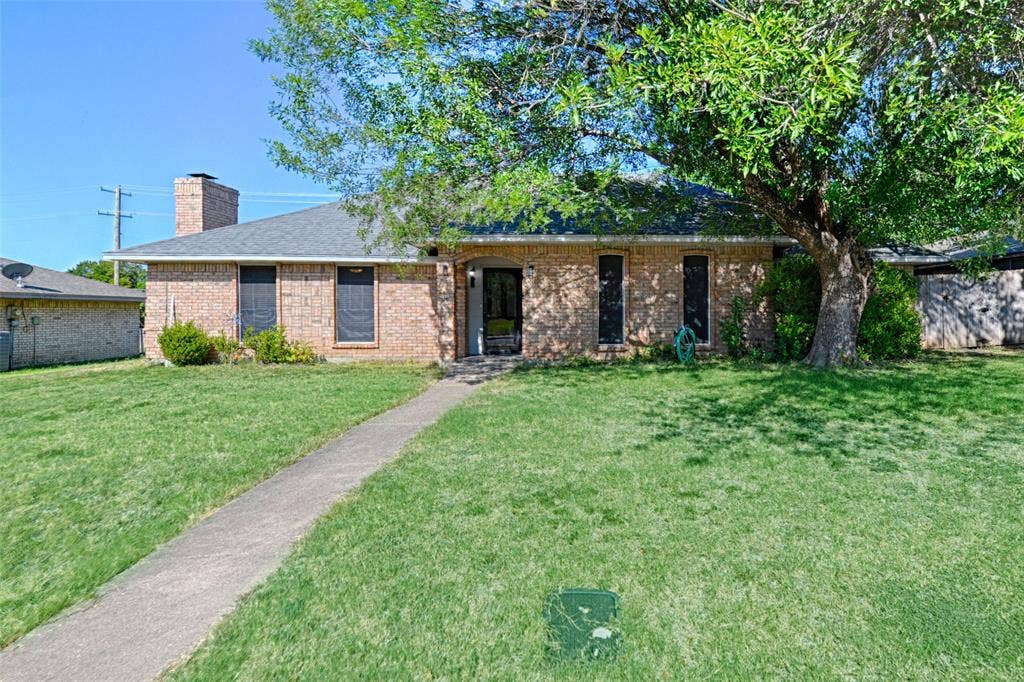 1223 Sequoia Drive, DeSoto, TX 75115 Brick exterior with a gabled roof and a prominent chimney