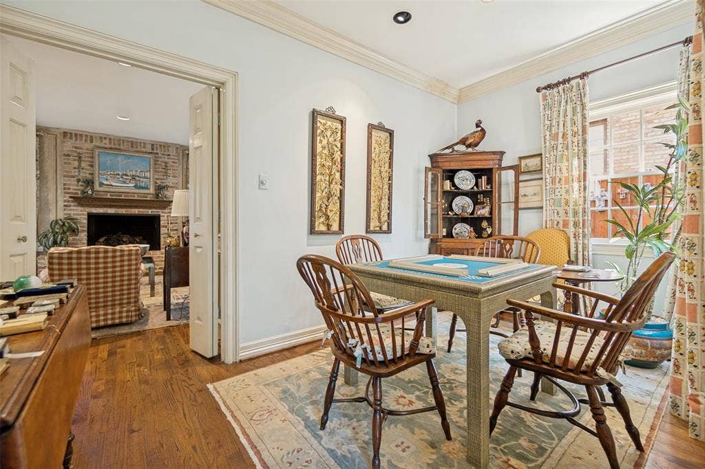 3418 Dartmouth Avenue, Highland Park, TX 75205 Hardwood flooring, crown molding, cased doorway, recessed lighting, and a brick fireplace