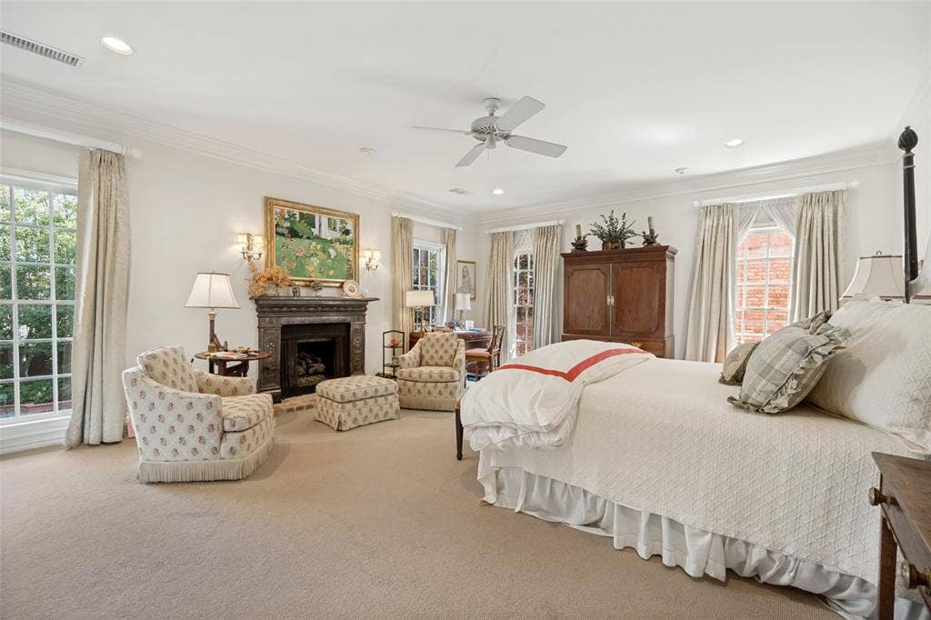3418 Dartmouth Avenue, Highland Park, TX 75205 Recessed lighting, crown molding, ceiling fan, decorative fireplace with stone mantel, and large windows