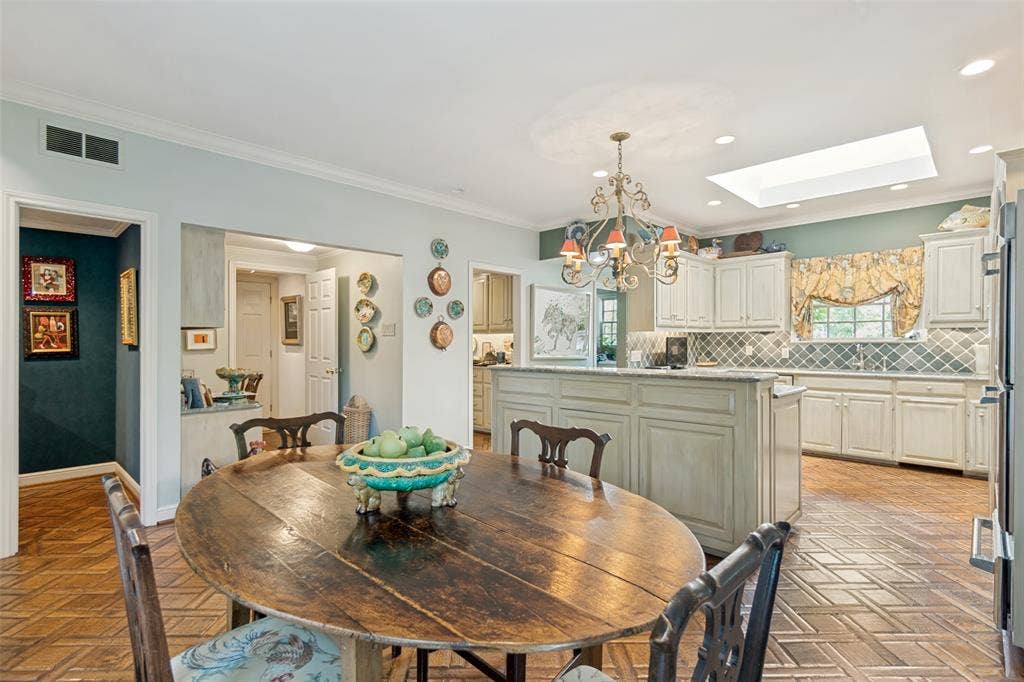 3418 Dartmouth Avenue, Highland Park, TX 75205 Kitchen featuring a center island, white cabinetry, decorative tile backsplash, recessed lighting, and a skylight