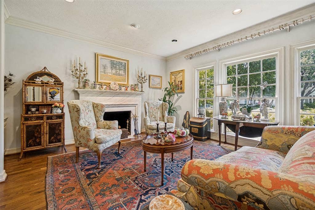 3418 Dartmouth Avenue, Highland Park, TX 75205 Hardwood flooring, crown molding, a white marble fireplace, recessed lighting, and multiple windows with grid patterns