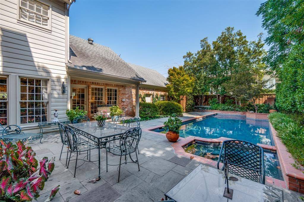 3418 Dartmouth Avenue, Highland Park, TX 75205 Expansive outdoor patio with a rectangular swimming pool, integrated spa, and mature landscaping