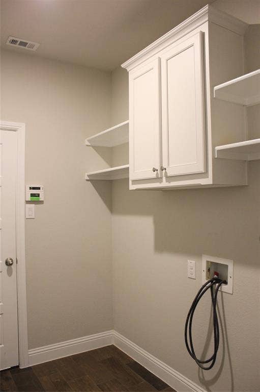 940 Parkside Drive, Argyle, TX 76226 Utility room with White shaker-style cabinetry with crown molding, integrated wall shelving, wood-finish flooring, and a laundry hookup station