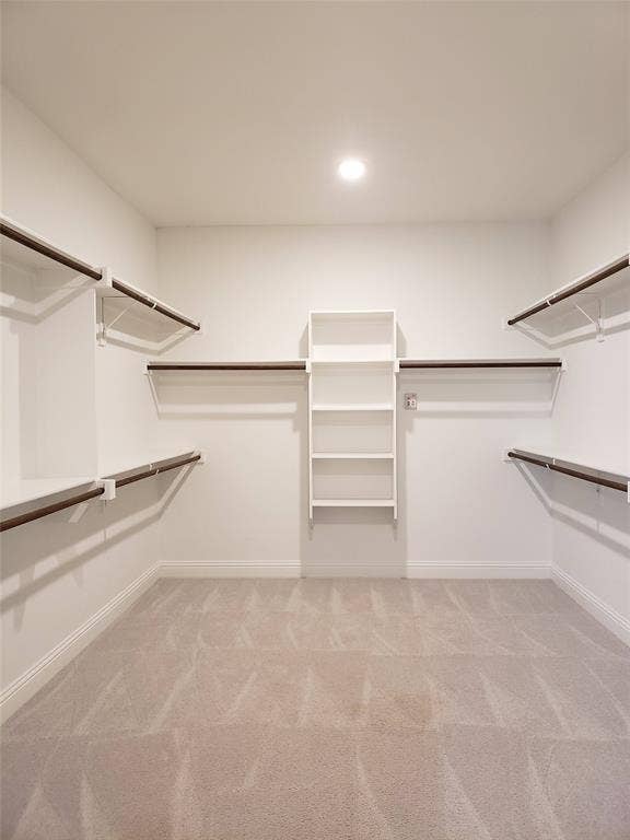 940 Parkside Drive, Argyle, TX 76226 Primary Bedroom with Spacious walk-in closet featuring light-toned carpeting, ample built-in shelving, and multiple hanging rods