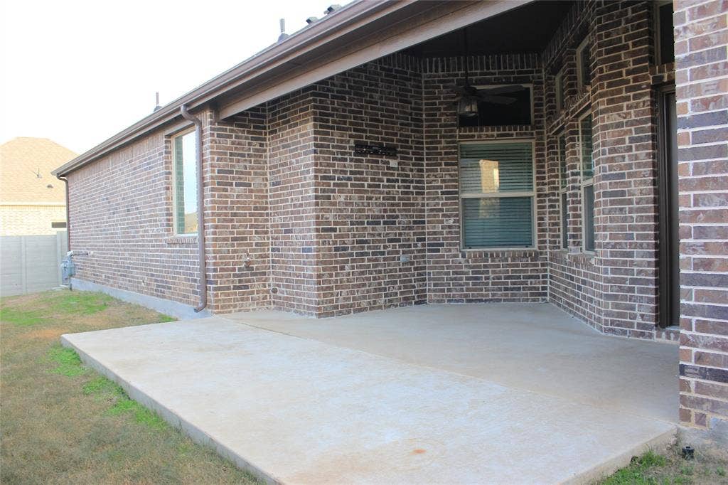 940 Parkside Drive, Argyle, TX 76226 Covered concrete patio with brick exterior and recessed lighting